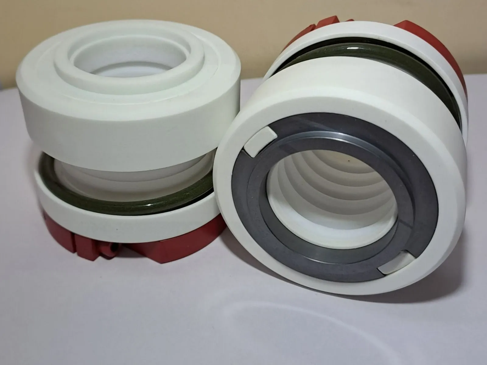 Two PTFE bellows mechanical seals with white PTFE bodies and ceramic seal faces